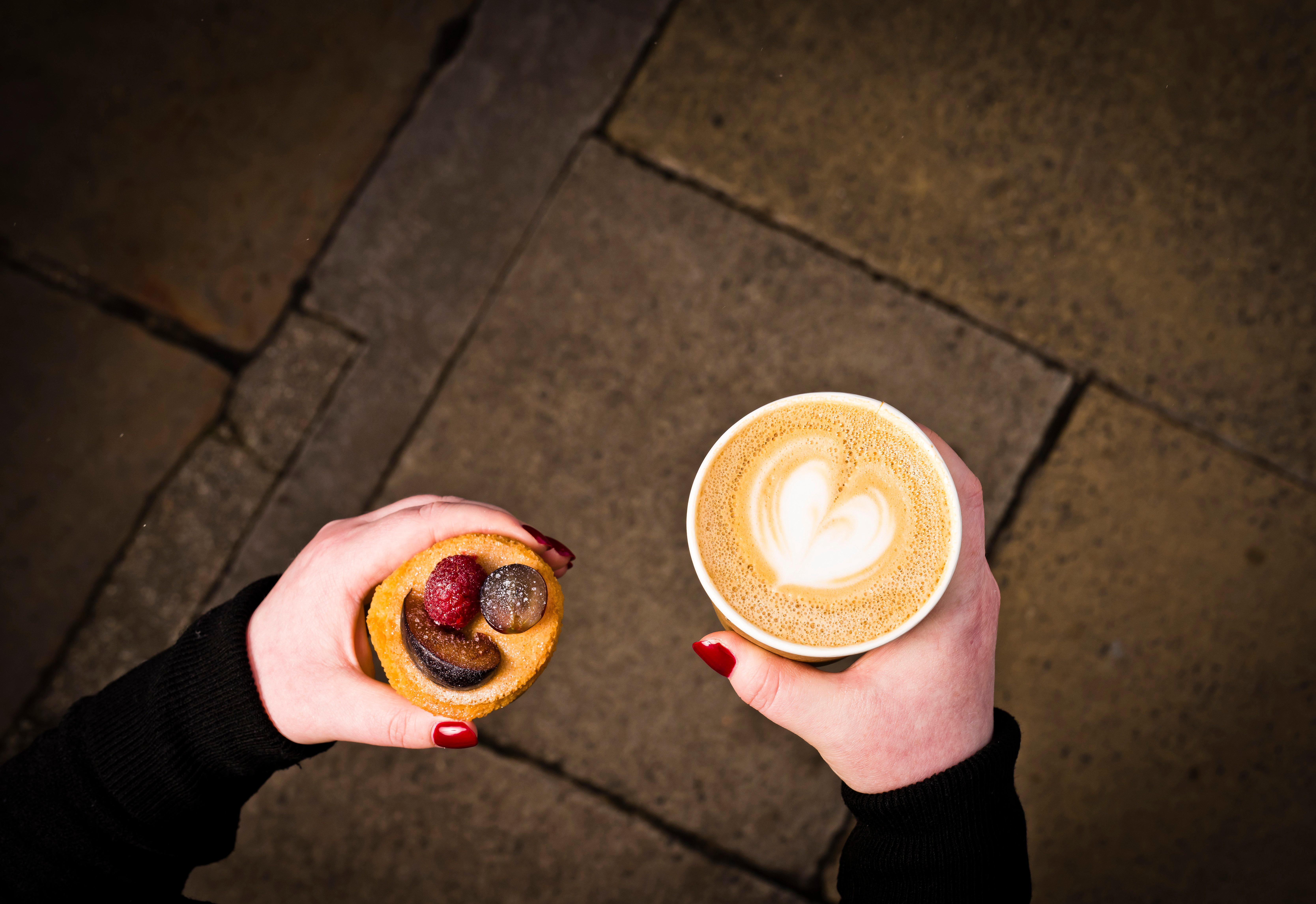 Intercontinental Edinburgh The George By Ihg Hotel Kültér fotó A woman holding a coffee and a doughnut